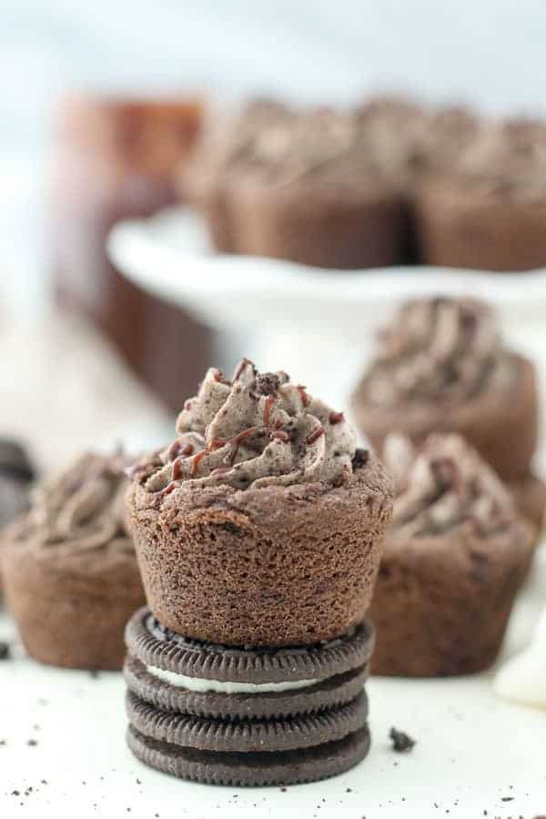 A mini Chocolate Oreo cookie cup sitting on top of two Oreos