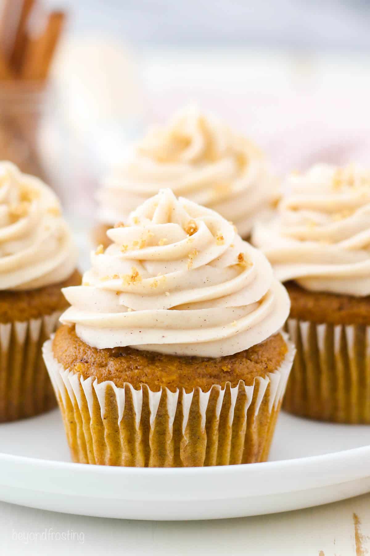 Pumpkin cupcakes with cream cheese frosting on a plate