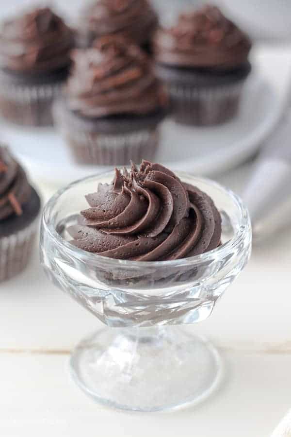 A small glass dish filled with swirls of chocolate cream cheese frosting