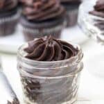 A close up of a mini jar with swirls of chocolate cream cheese frosting