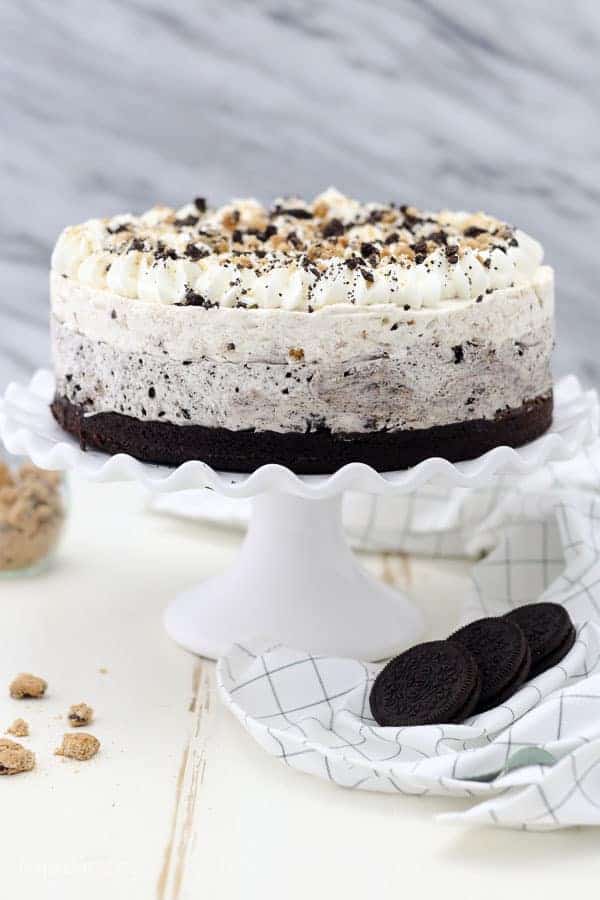 A Oreo Brookie Mousse Cake on a white rimmed caked stand