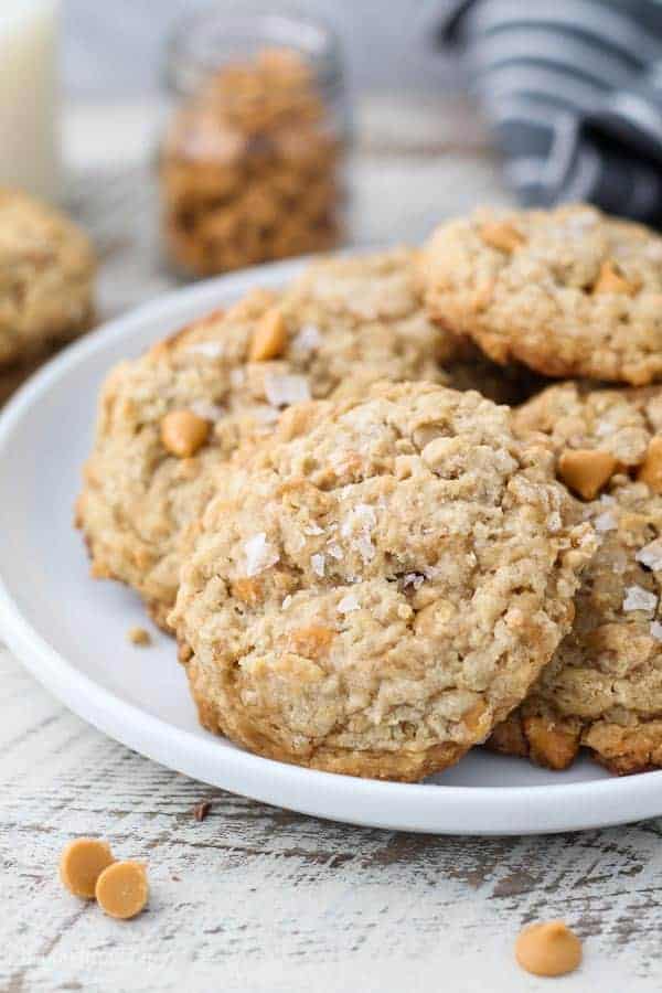 A gorgeous plate of butterscotch oatmeal cookies loaded with butterscotch chips and sprinkled with a flakey sea salt