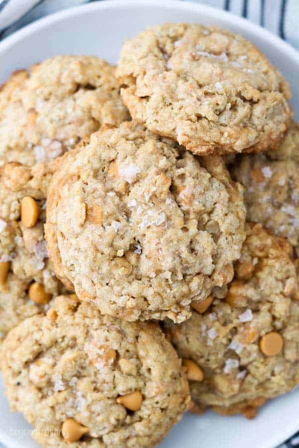 An overhead view of a gorgeous plate of butterscotch oatmeal cookies sprinkled with salted caramel