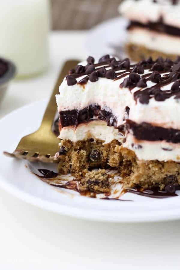 A big bite is taken out of this chocolate chip layered dessert with a cookie on the bottom