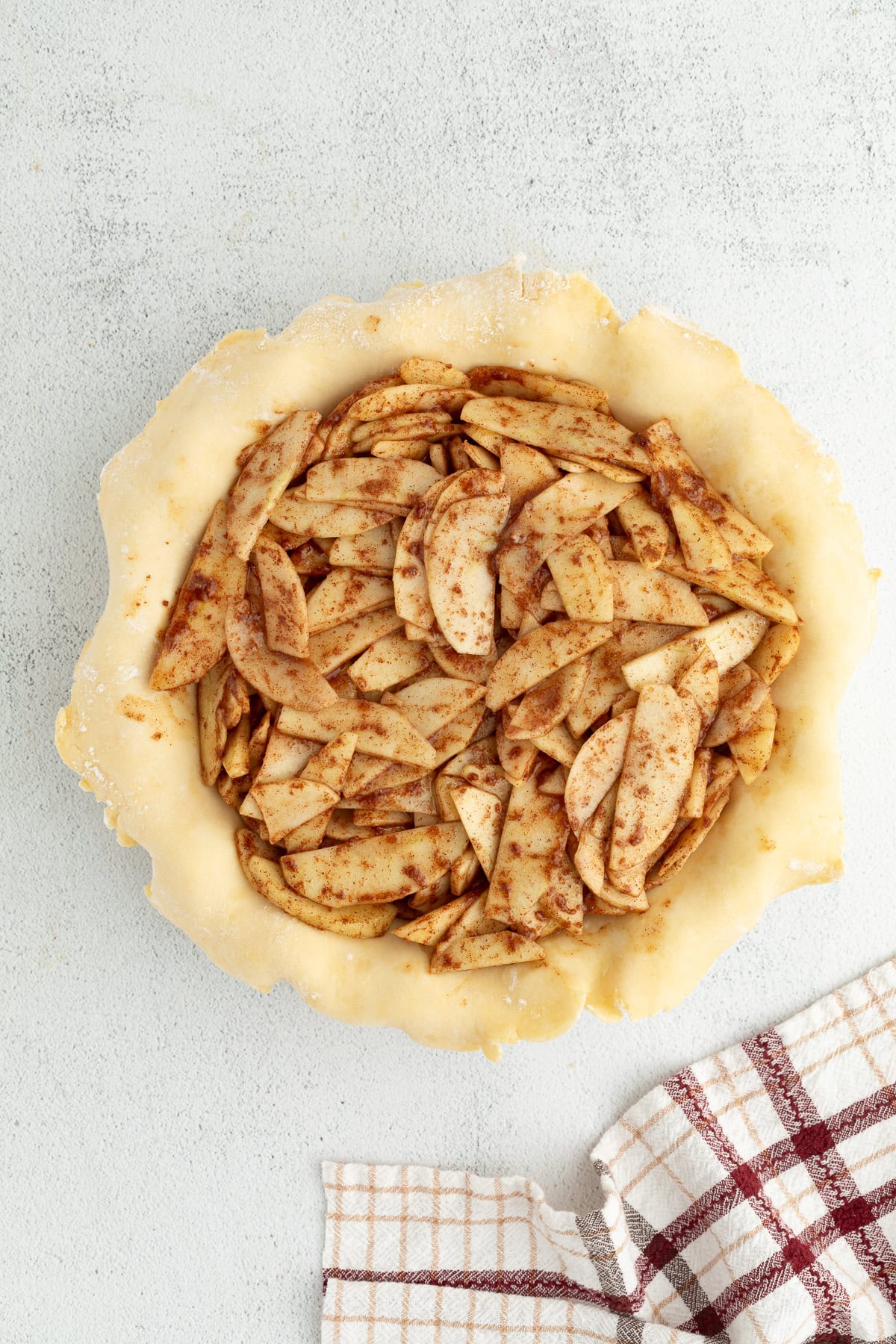 Apple pie filling inside a pie crust.
