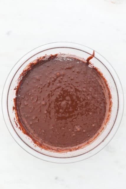 Chocolate cake batter in a glass bowl.