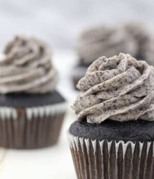 A close up shot of a chocolate cupcake frosted with the best Oreo frosting