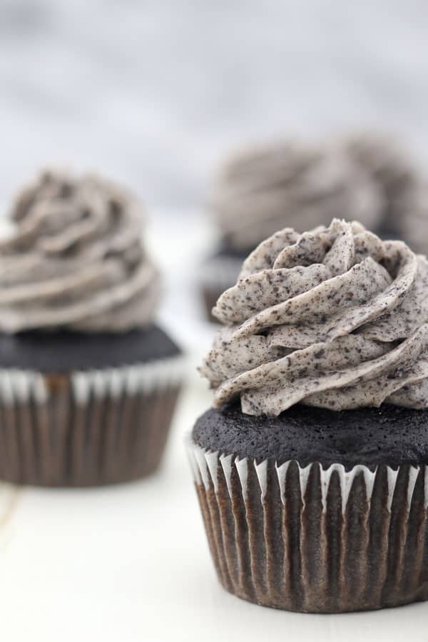 A close up shot of a chocolate cupcake frosted with the best Oreo frosting