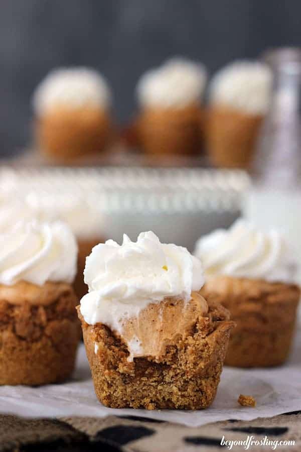 A deep dish cookie cup with a pumpkin filling. The cookie has a big bite taken out of it.