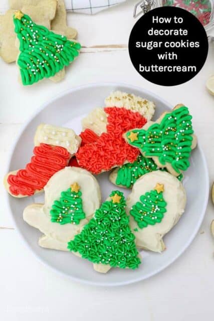 Plate with frosted sugar cookies decorated with buttercream.