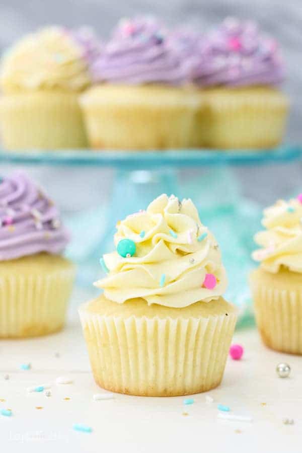 Lots of beautiful cupcakes frosted with Swiss Meringue Buttercream that is covered with colorful sprinkles
