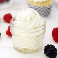A piped swirl of mascarpone whipped cream in a glass jar.