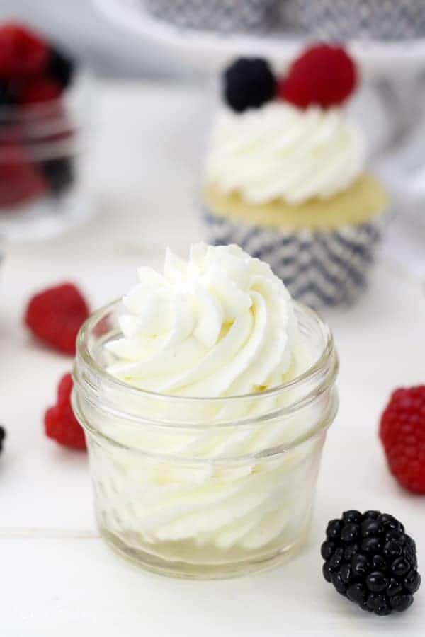 A mini mason jar filled with a gorgeous swirl of mascarpone whipped cream
