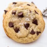 Close up of a chewy chocolate chip cookie sprinkled with sea salt.
