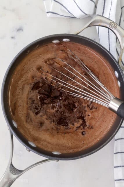 Adding chocolate with a whisk.