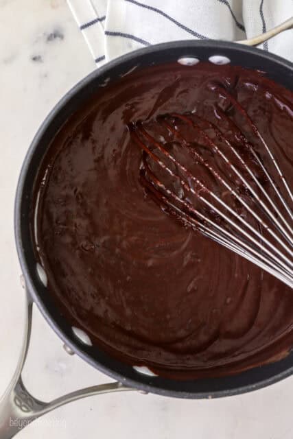 Whisking butter and vanilla into the chocolate mixture.