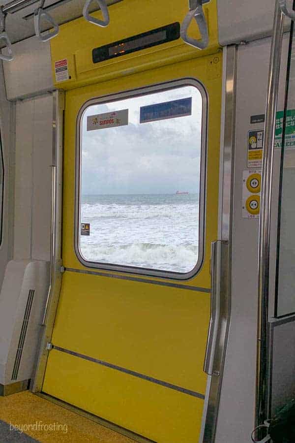 A view of the ocean out the window of the subway along the coast in Sapporo