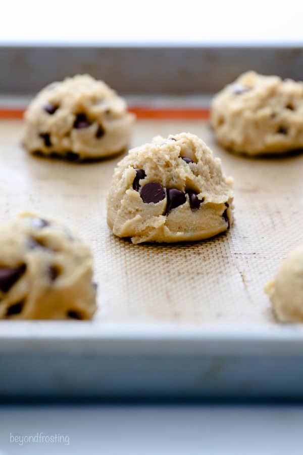 A scoop of raw cookie dough on a baking sheet
