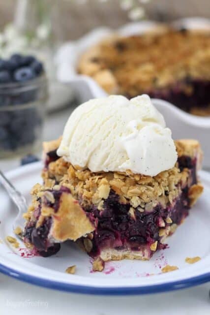 This slice of blueberry pie is filled with fresh blueberries and atop a flaky, buttery crust.