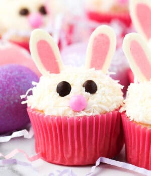 Assorted Easter bunny cupcakes in pink liners decorated with chocolate ears.