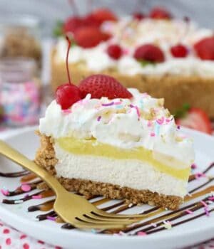 A gorgeous slice of a no-bake banana split pie to show all the layers including cheesecake, banana pudding, whipped cream and lots of sundae toppings