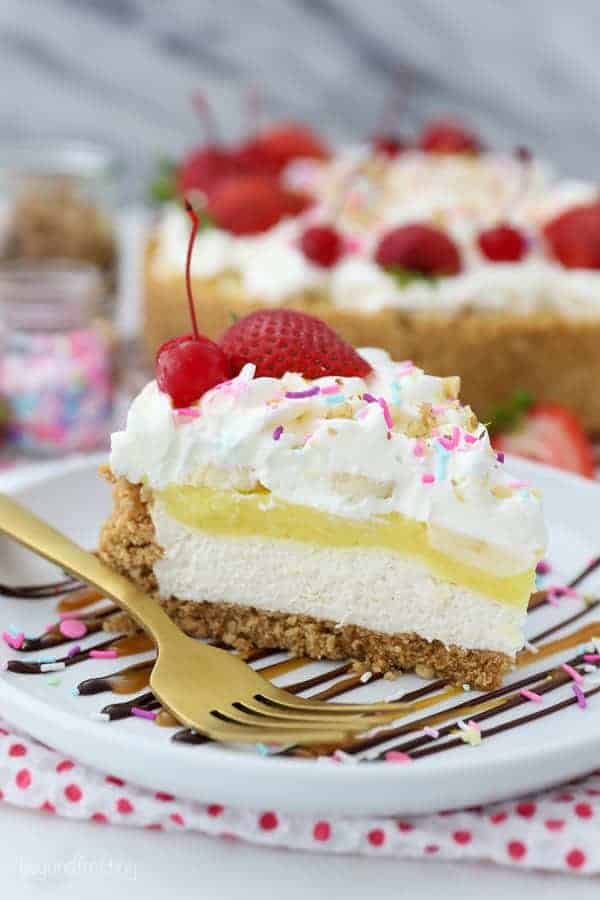 A gorgeous slice of a no-bake banana split pie to show all the layers including cheesecake, banana pudding, whipped cream and lots of sundae toppings