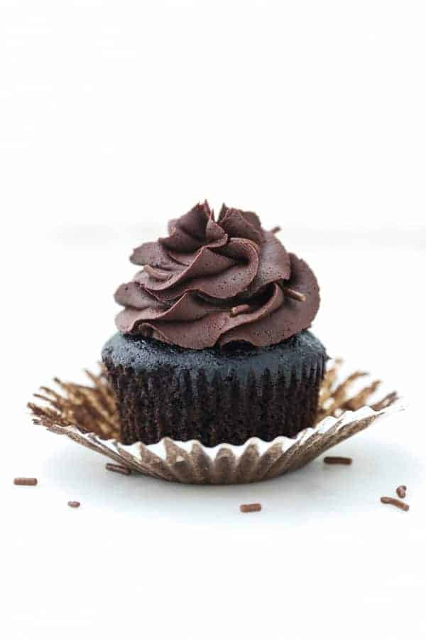 A gorgeous unwrapped chocolate cupcake with a gorgeous chocolate frosting
