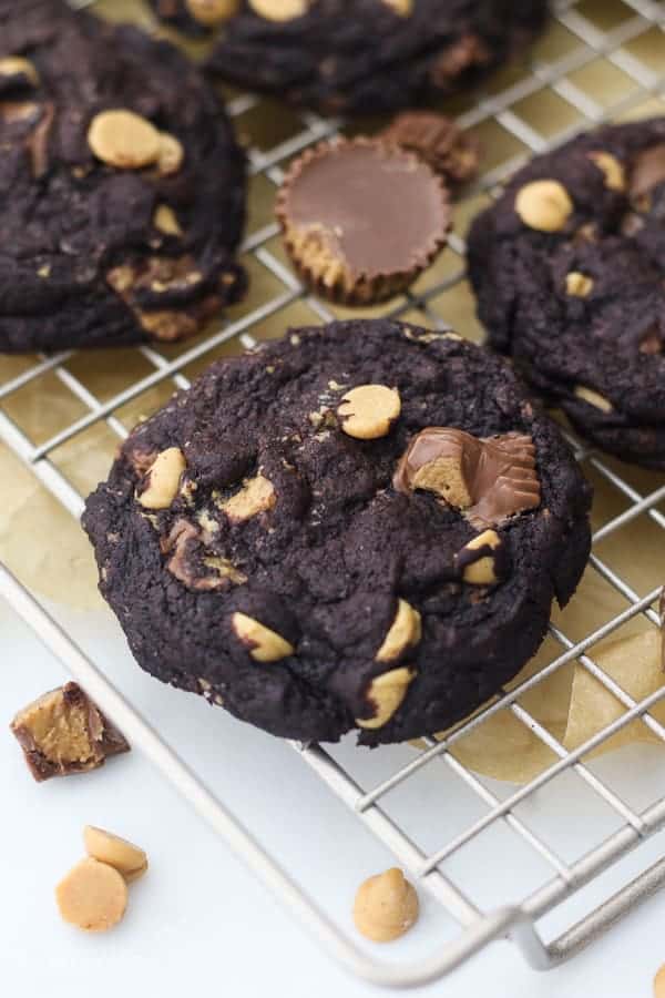 An overhead view of a double chocolate peanut butter cookie on a wire cooking rack