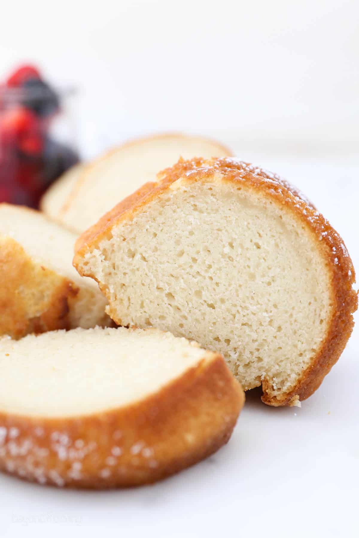 Slices of vanilla bundt cake on a white countertop.