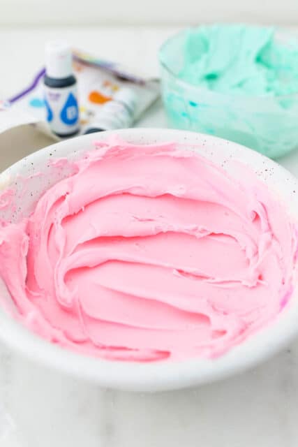 A bowl of pink buttercream frosting.
