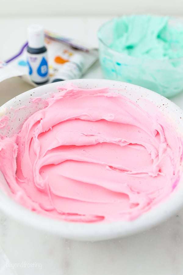 A white bowl filled with dreamy pink buttercream