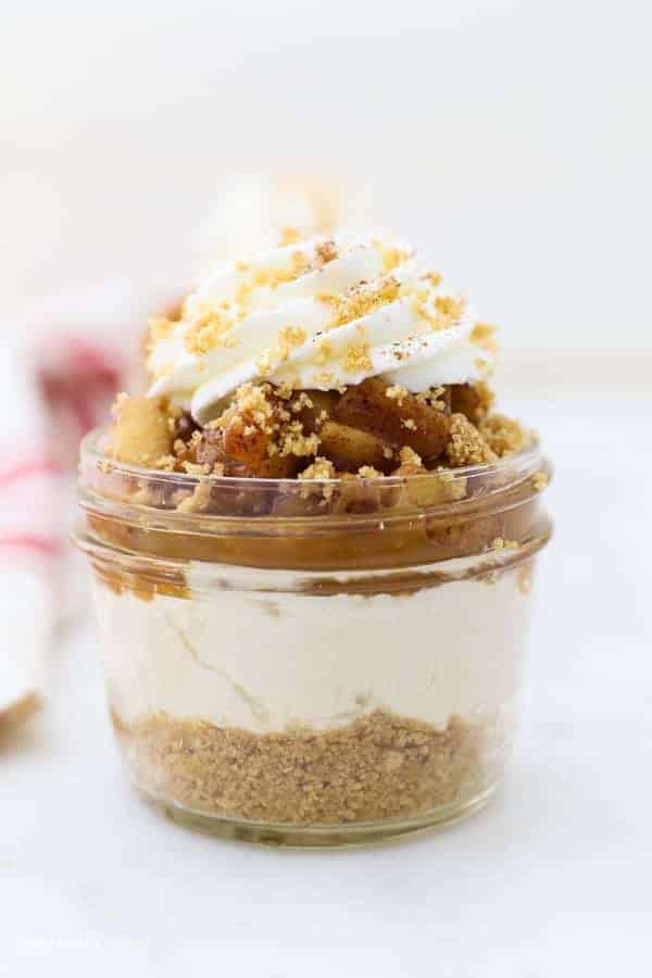 A gorgeous apple cheesecake in a jar showing all the different layers of the dessert