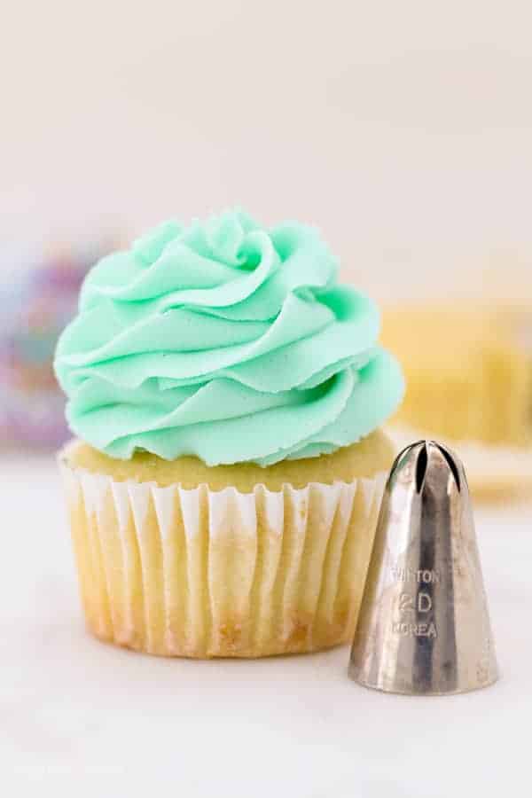 A cupcake decorating with a 2D piping tip, also known as a drop star tip
