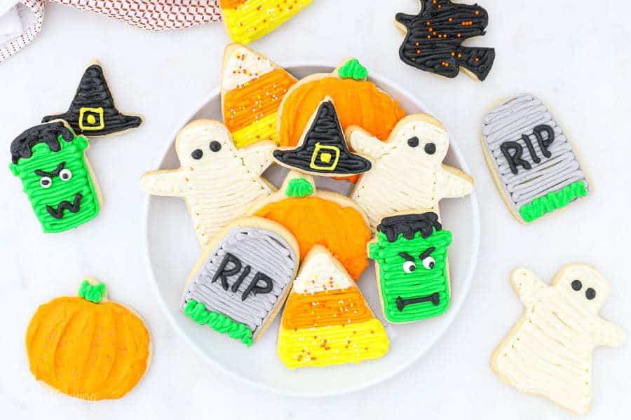 Plate of  decorated halloween sugar cookies: tombstone, ghost, candy corn and Frankenstein. 