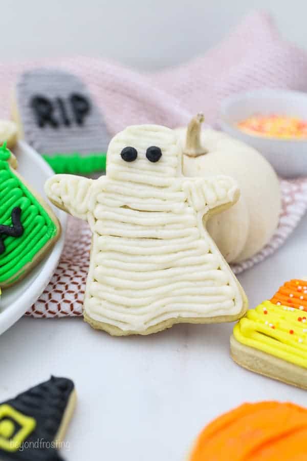 A ghost cookie decorated with buttercream