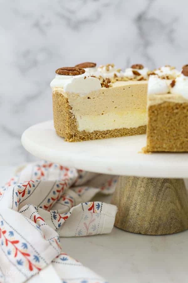 Side view of a slice missing from a White Chocolate Pumpkin Mousse Cake