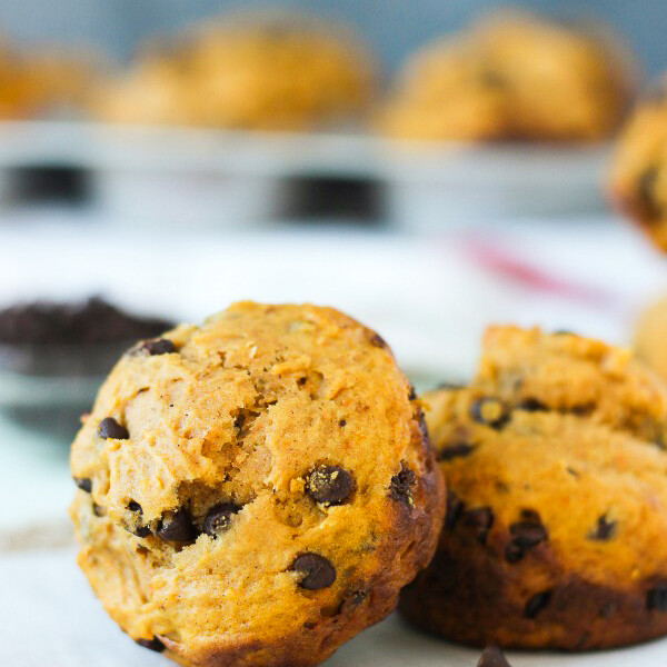 A sweet potato muffin leaning up against another muffin