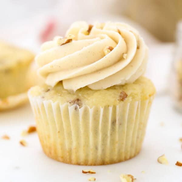Close up of a pecan cupcake frosted with maple buttercream.