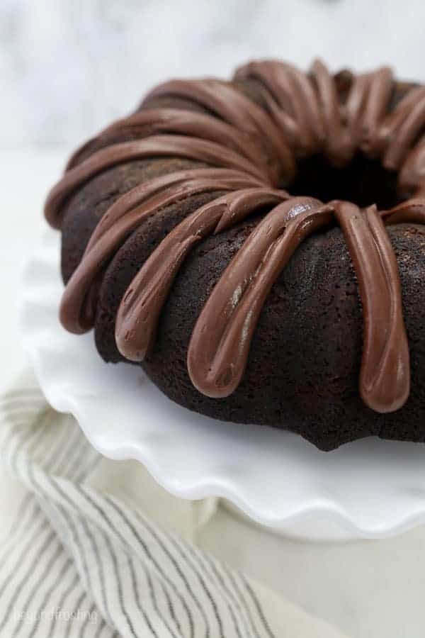 An overhead shot of a chocolate bundt cake with a chocolate frosting