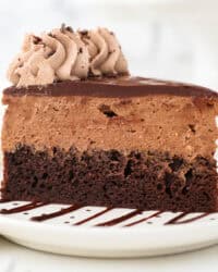 A slice of chocolate mousse cake on a white plate.