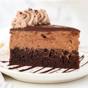 A slice of chocolate mousse cake on a white plate.