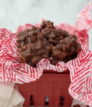 A cute red berry basket filled with festive peanut clusters