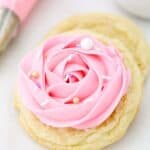 A gorgeous sugar cookie decorated with a 1M pink rose with gorgeous sprinkles
