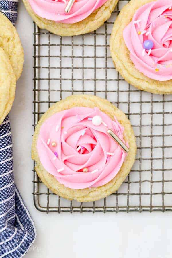 Sugar cookies decorated with a pink rose and pretty sprinkles