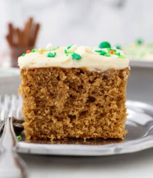 A slice of gingerbread cake on a plate next to a fork.