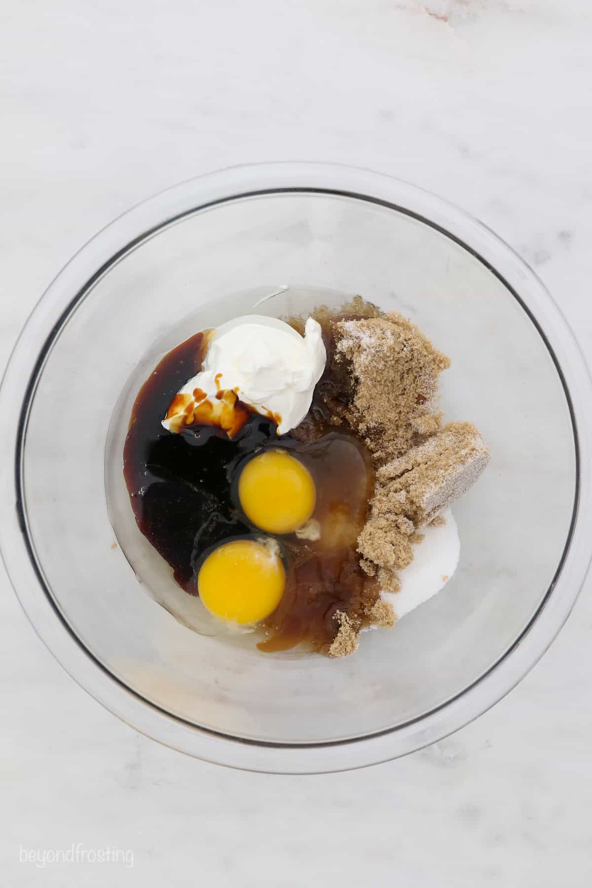 Wet cake ingredients combined in a glass bowl.