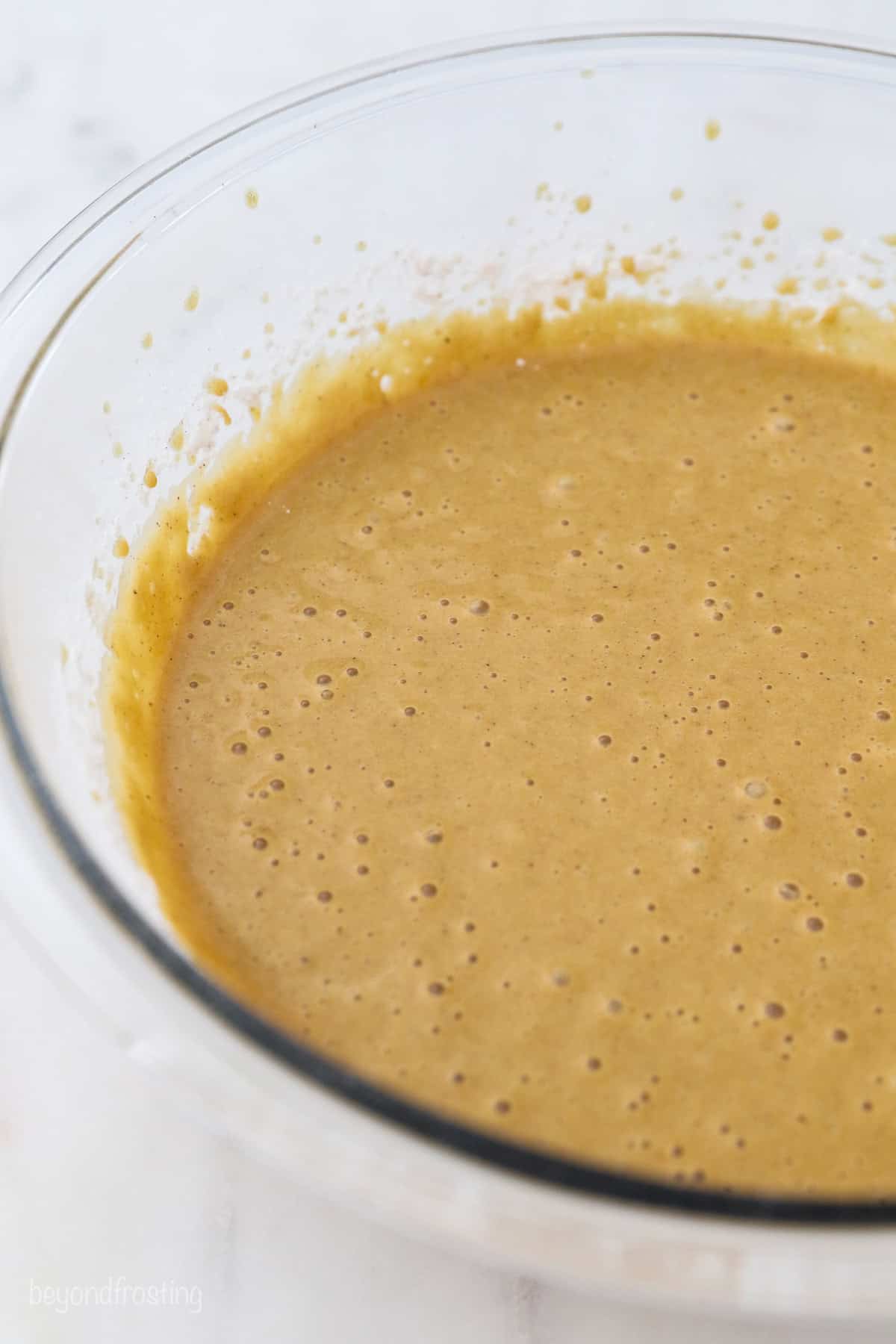 Gingerbread cake batter in a glass bowl.