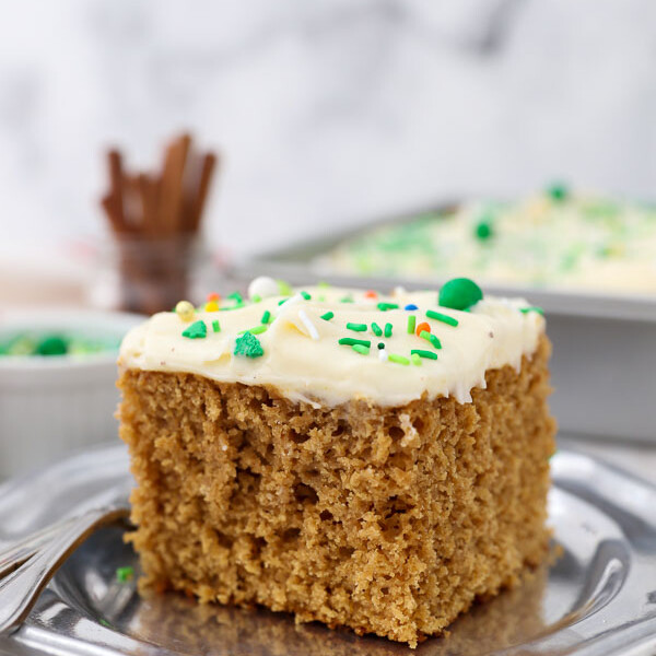 A overhead shot of a slice of Gingerbread Cake on a vintage silver plate with silver forks