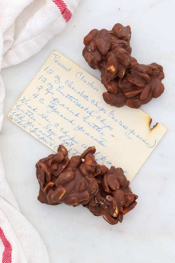 4 peanut clusters sitting on top of a vintage recipe card