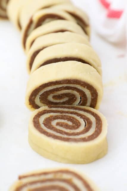 Rolled pinwheel cookie dough cut into slices.